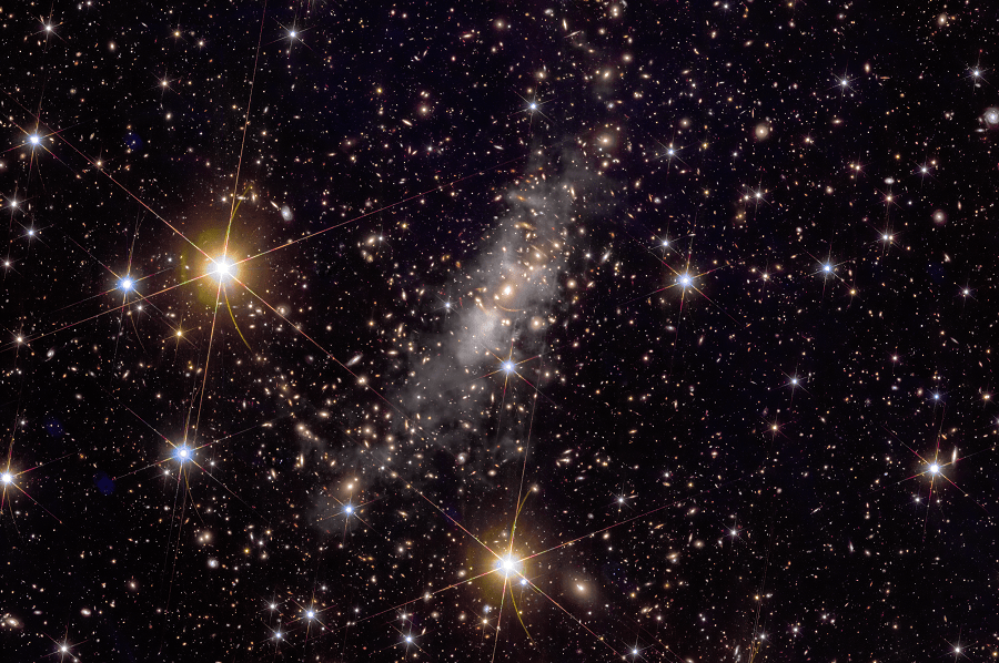 Euclid’s image of this galaxy cluster reveals more than 50,000 galaxies and shows a display of gravitational lensing, depicting giant curved arcs on the sky – some of which are actually multiple views of the same distant object. Credit: ESA