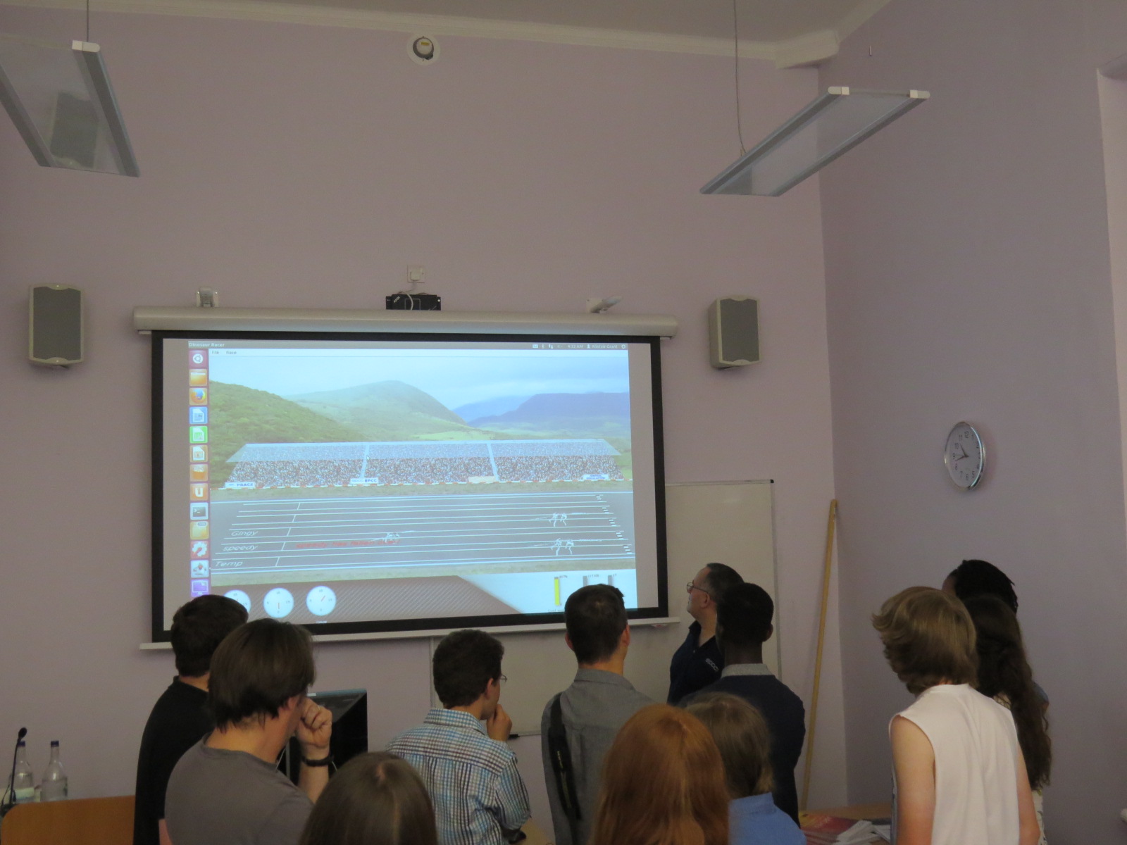 Attendees look on as dinosaurs race to victory.