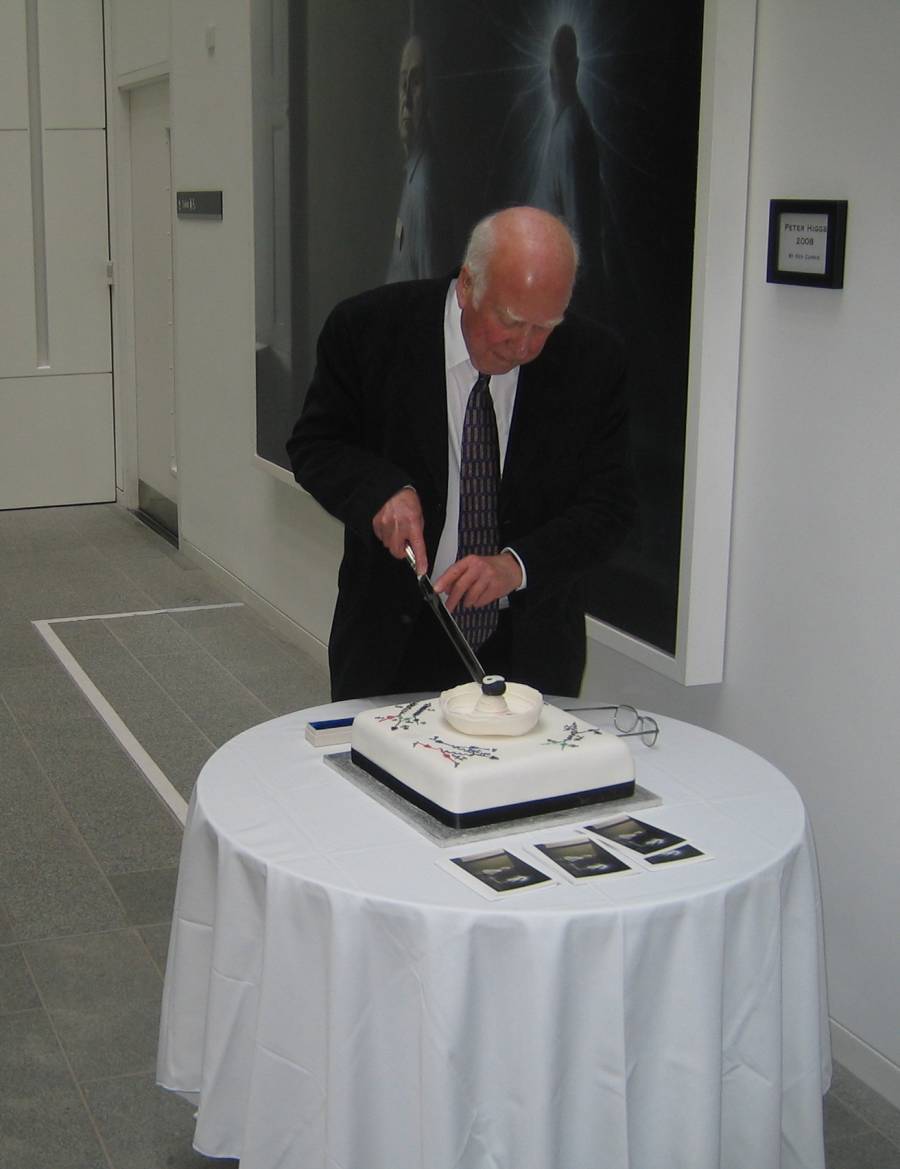 Peter Higgs cutting his 80th birthday cake.