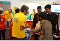 Wahid running the lucky dip for rare-decays of the Higgs Boson (in pin-badge form).